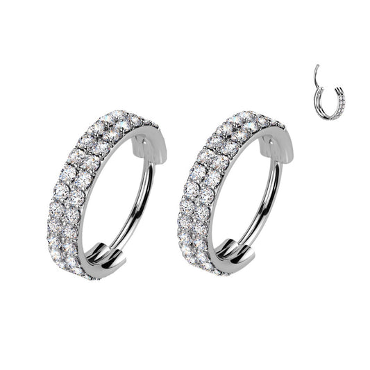 Pair of silver hoop earrings with clear gemstones.