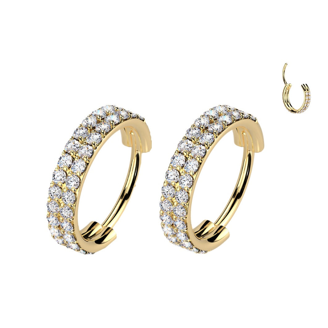 Gold hoop earrings with clear gemstones.