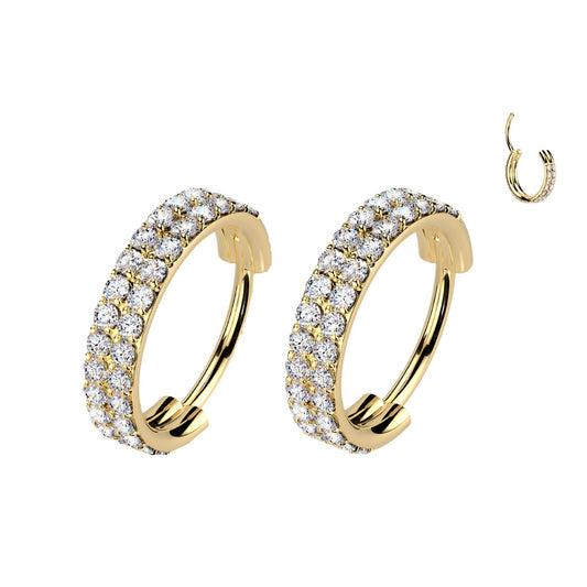 Gold hoop earrings with clear gemstones.