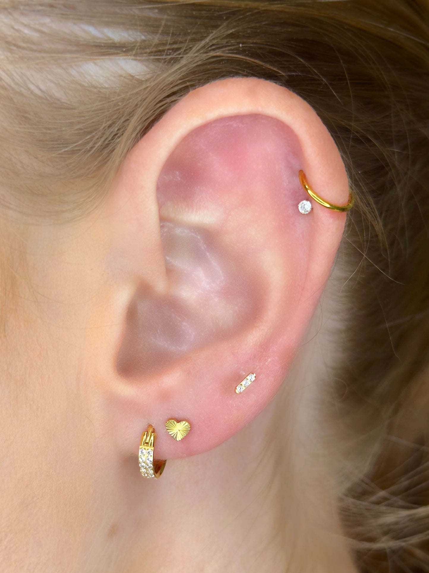 Close-up picture showing the earrings on a real ear.