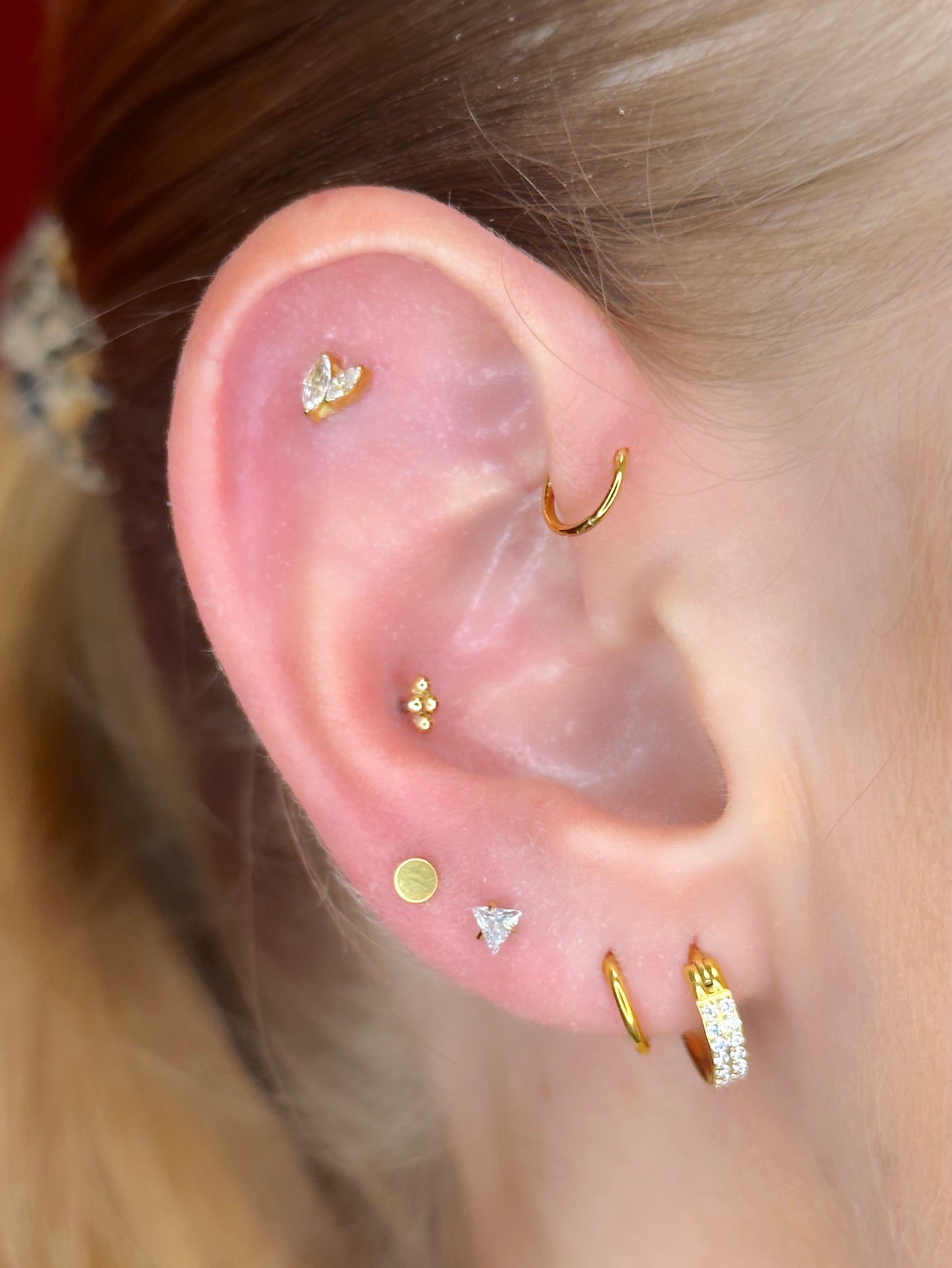 Close-up picture showing the earrings on a real ear.