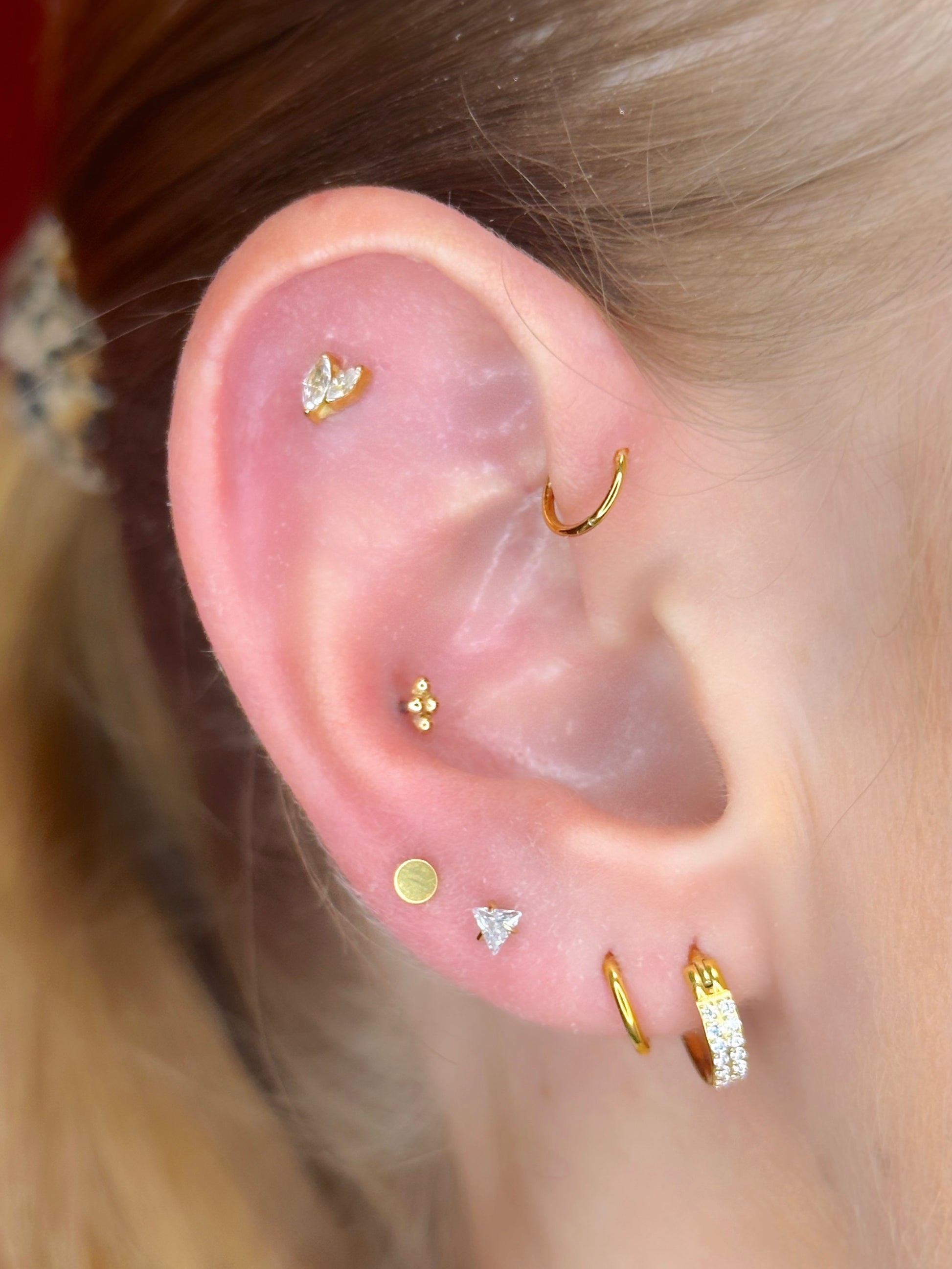 Close-up picture showing the earrings on a real ear.