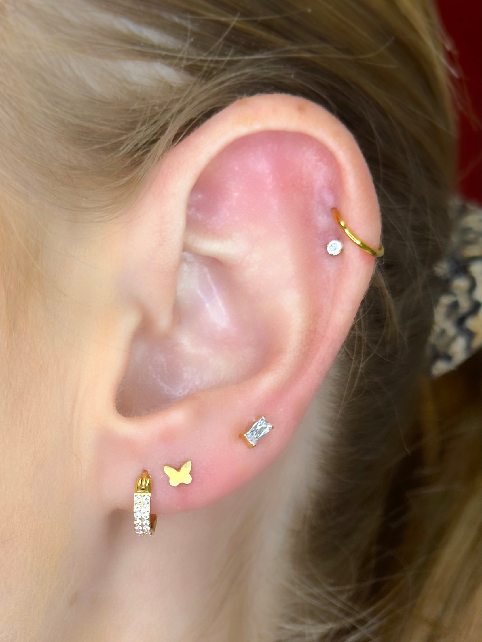 Close-up picture showing the earrings on a real ear.
