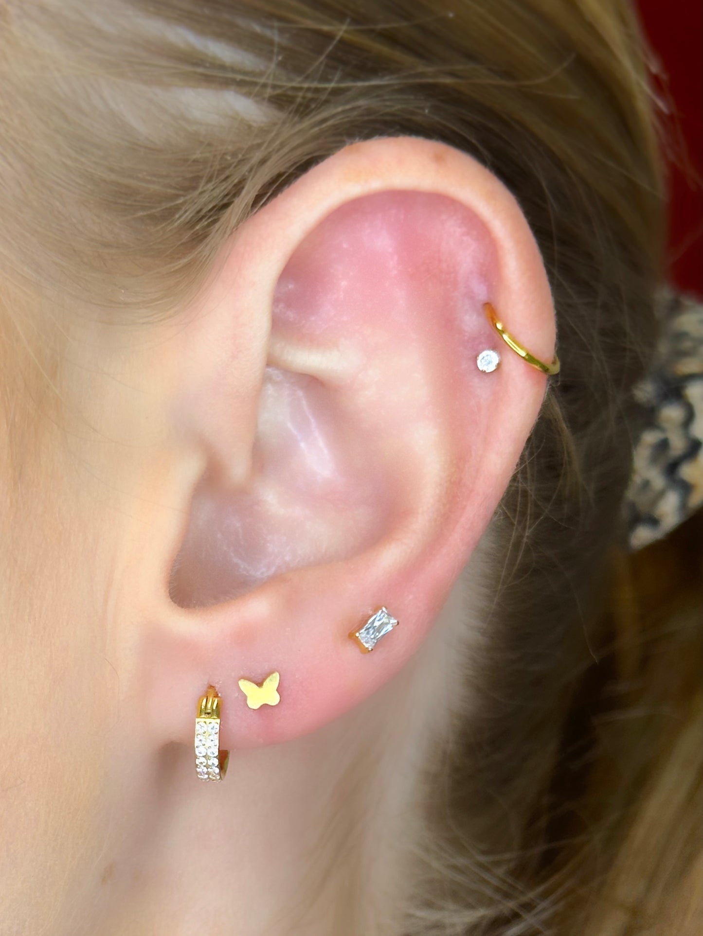 Close-up picture showing the earrings on a real ear.