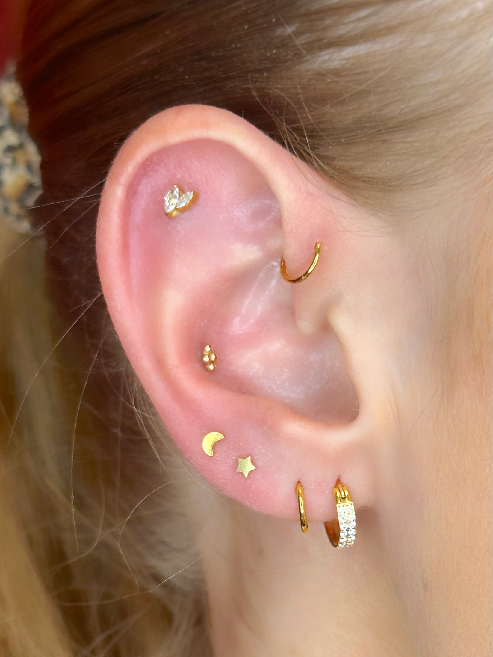 Close-up picture showing the earrings on a real ear.