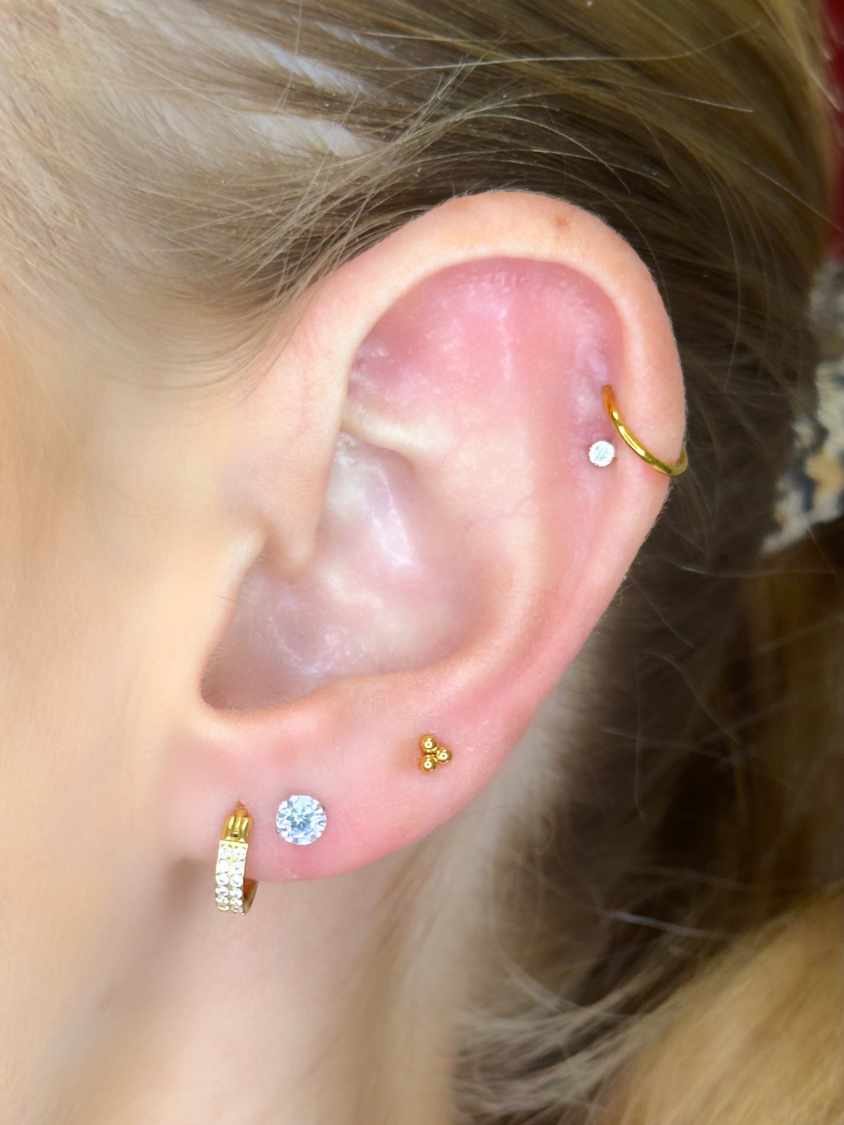 Close-up picture showing the earrings on a real ear.