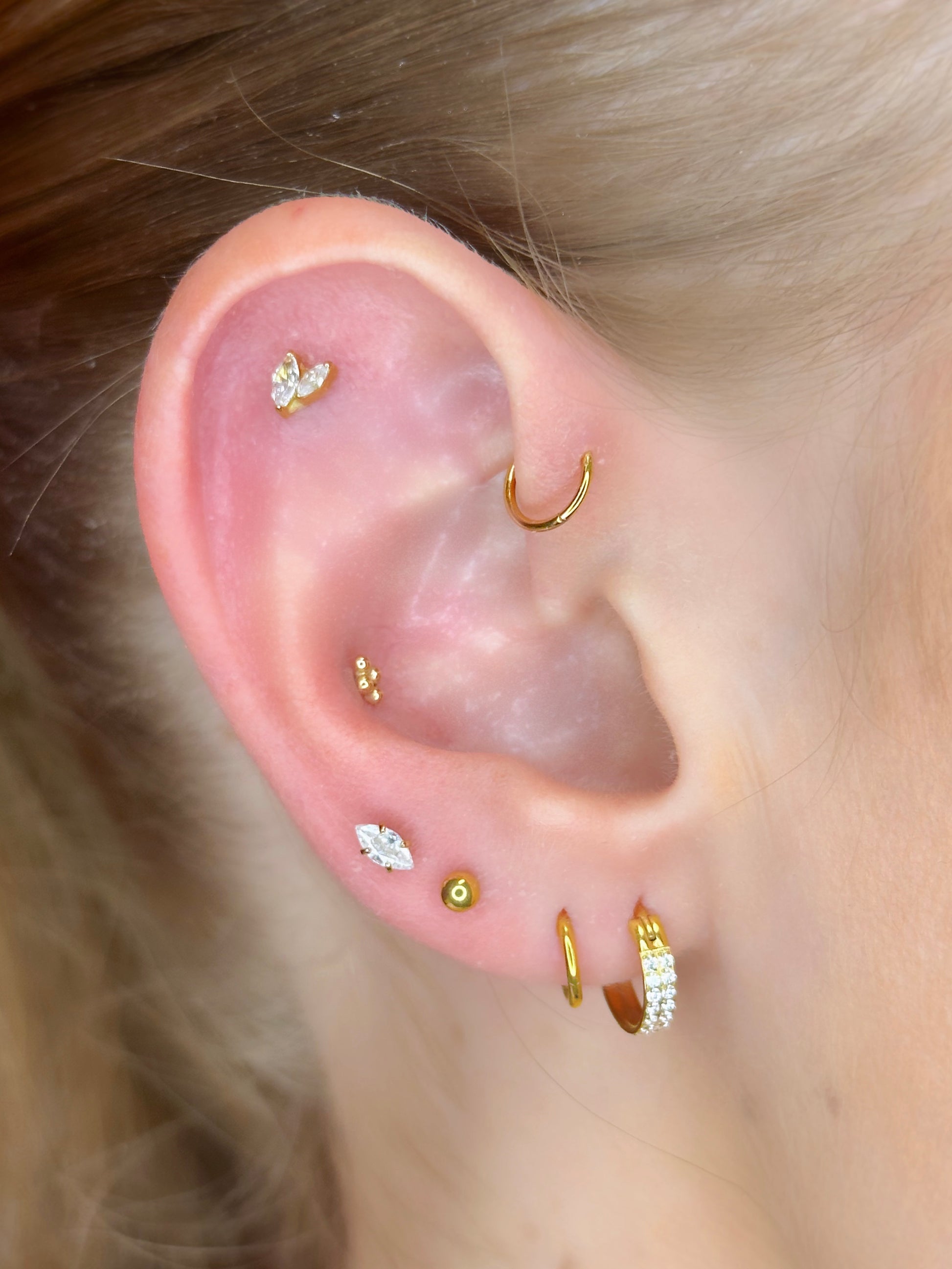 Close-up picture showing the earrings on a real ear.