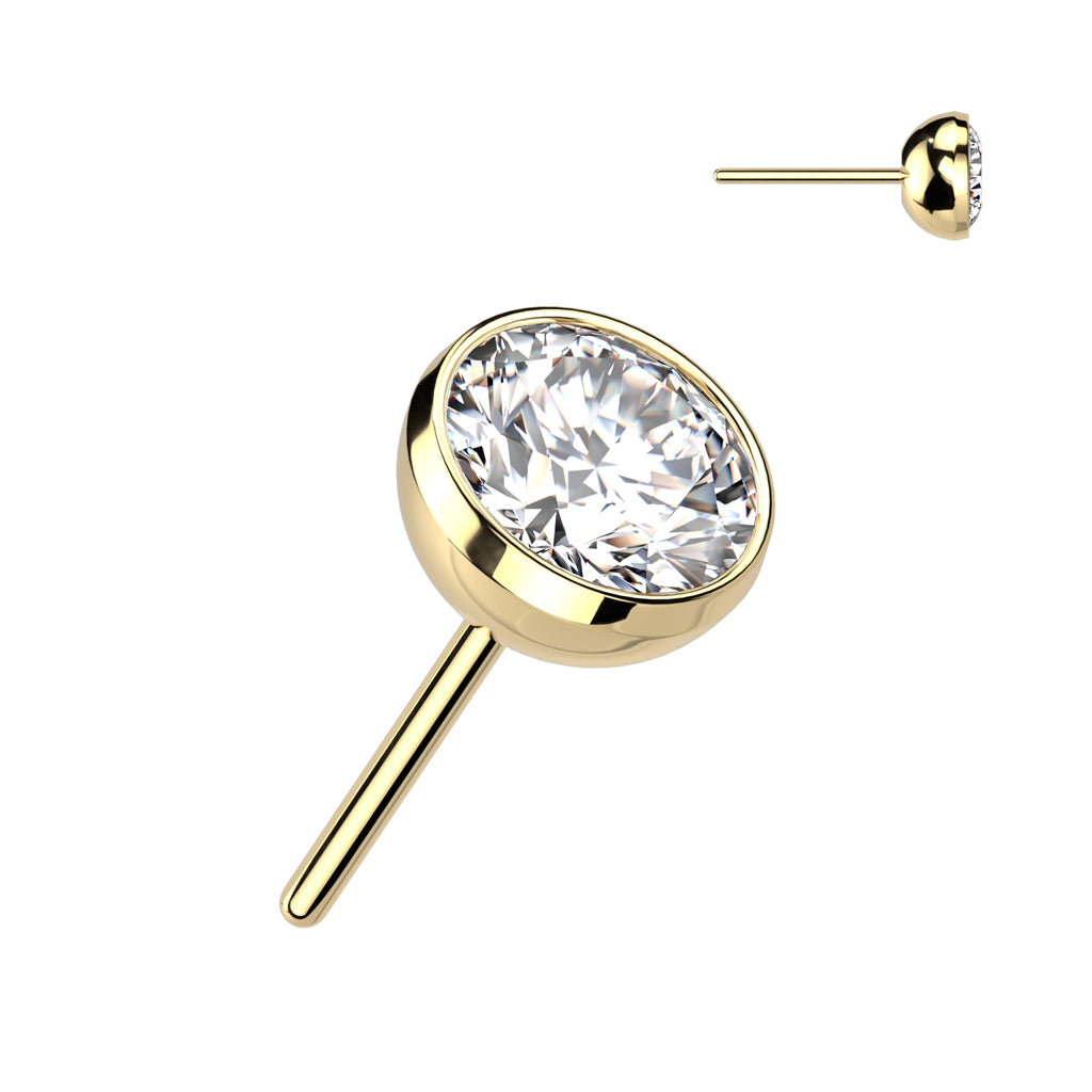 Gold stud earring with a clear gemstone.