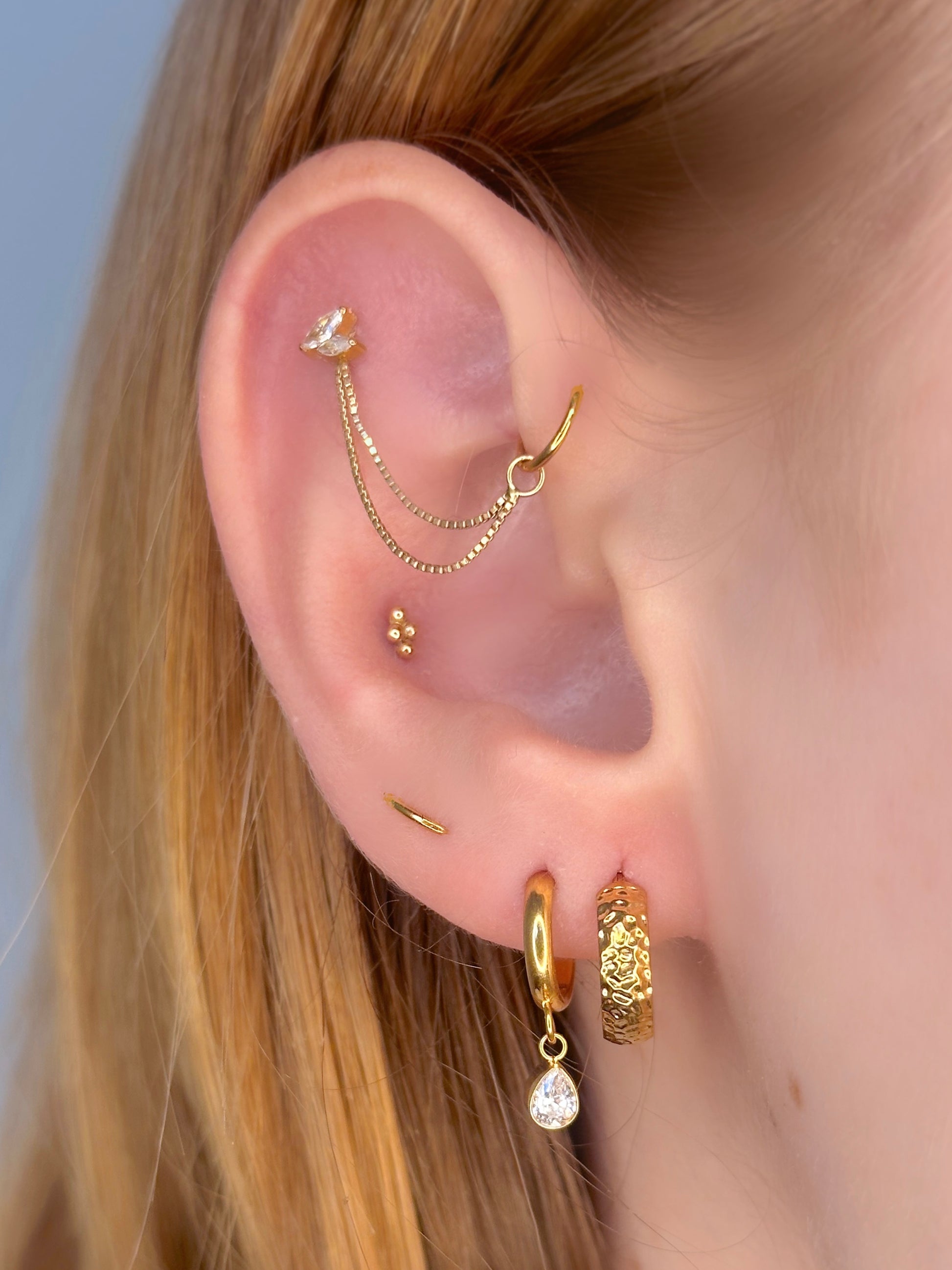 Close-up picture showing the earrings on a real ear.